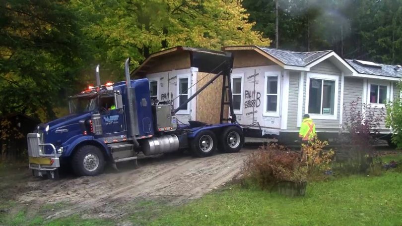 Truck carrying mobile home