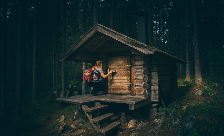 Entering a small log cabin